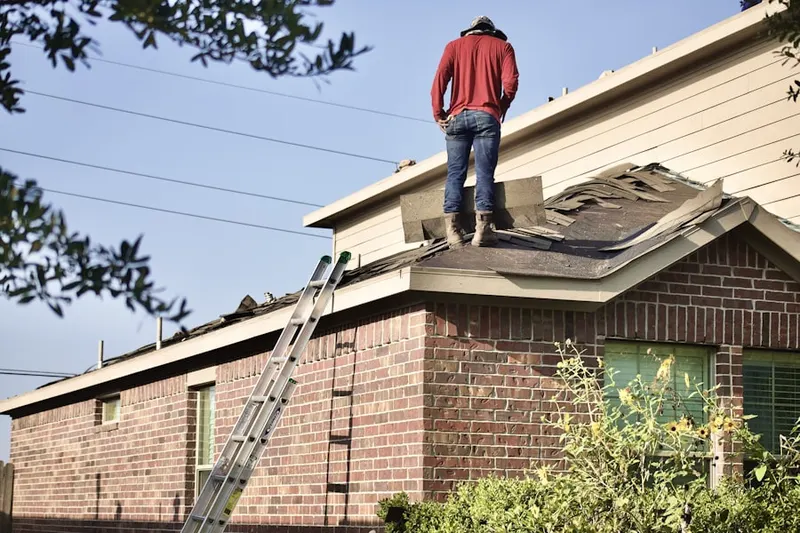 Professional roofer working on a residential roof in South Salem